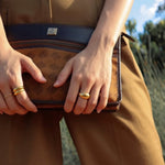 girl stacking gold dome rings 