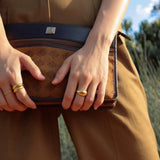 girl stacking gold dome rings 