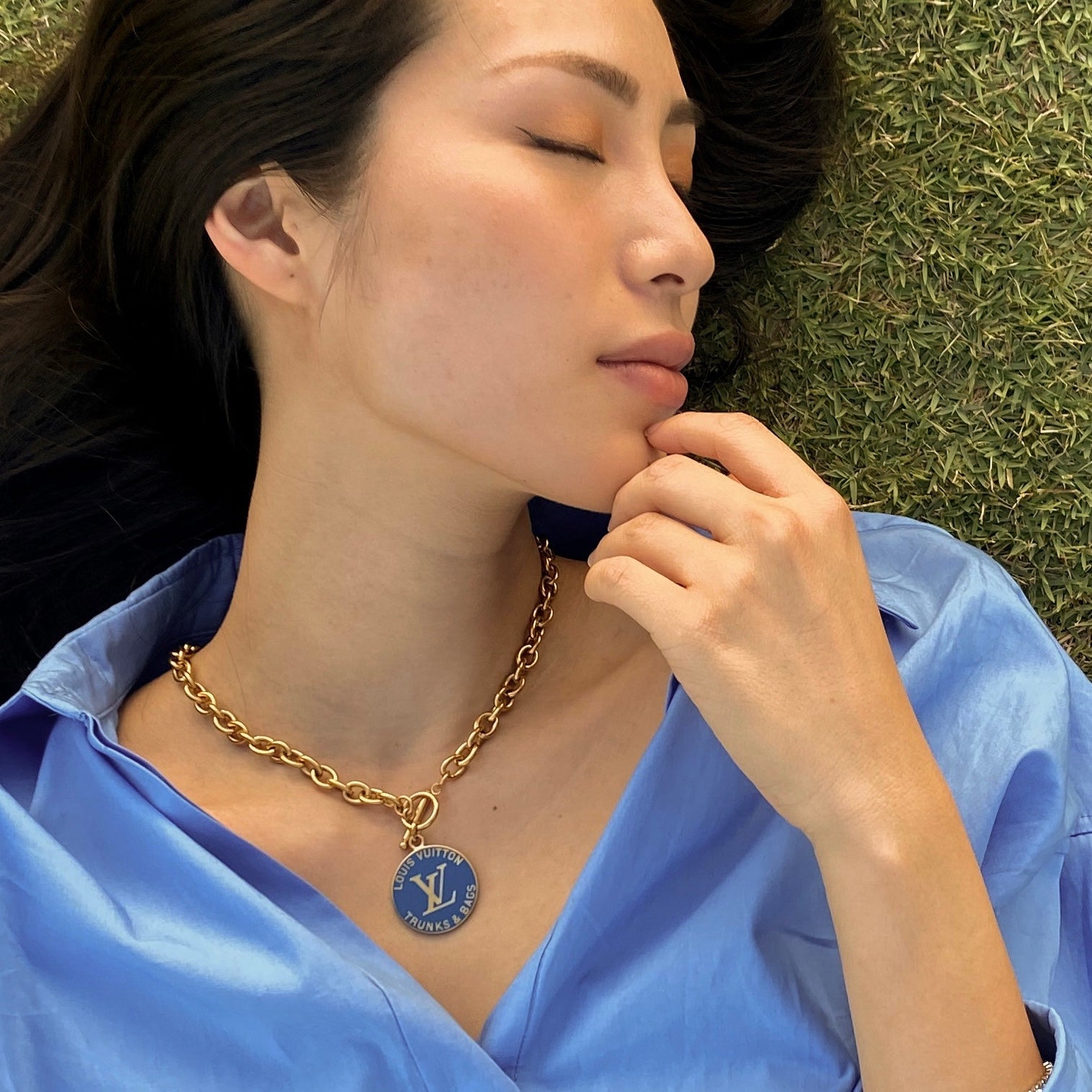 girl wearing repurposed designer louis vuitton chunky necklace upcycled from vintage LV bag charm