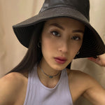 girl wearing silver hoop earrings with repurposed prada choker necklace